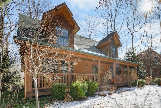 view of side of home with a porch