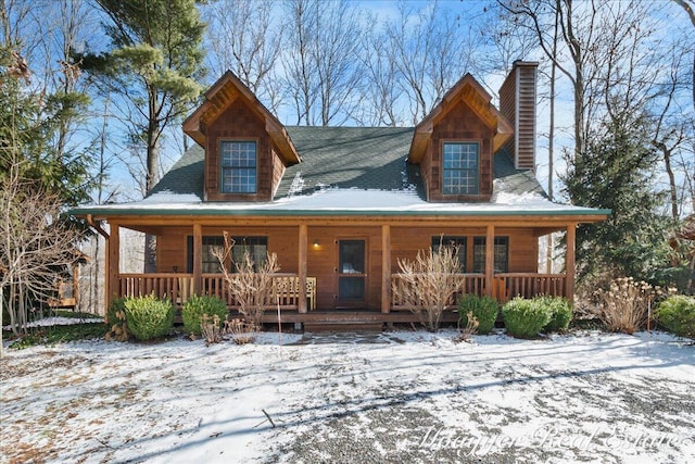 view of front of house featuring covered porch and a chimney