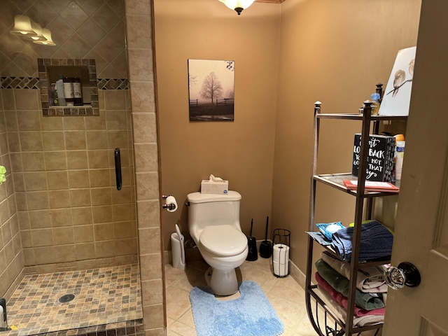 full bathroom with a stall shower, tile patterned flooring, toilet, and baseboards