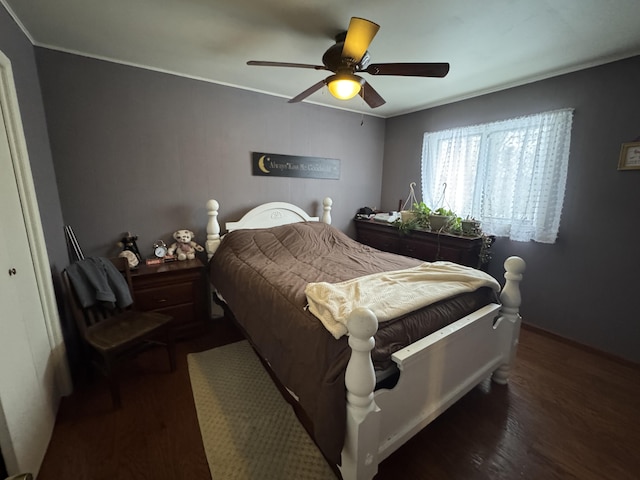 bedroom with ceiling fan, ornamental molding, and wood finished floors