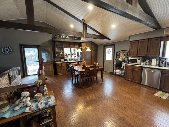 kitchen featuring vaulted ceiling with beams, white microwave, dark wood-type flooring, light countertops, and stainless steel dishwasher