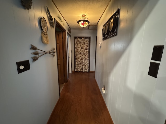 hall featuring a textured ceiling and wood finished floors