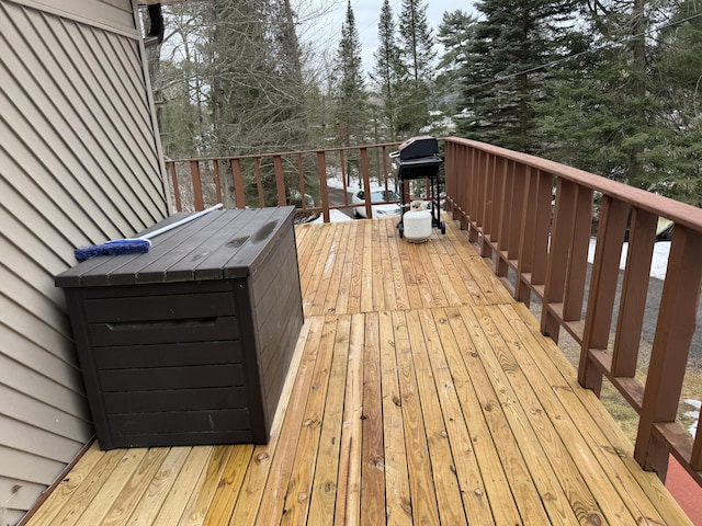 wooden deck with a grill