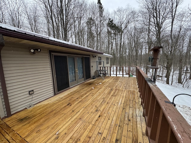 snow covered deck with french doors