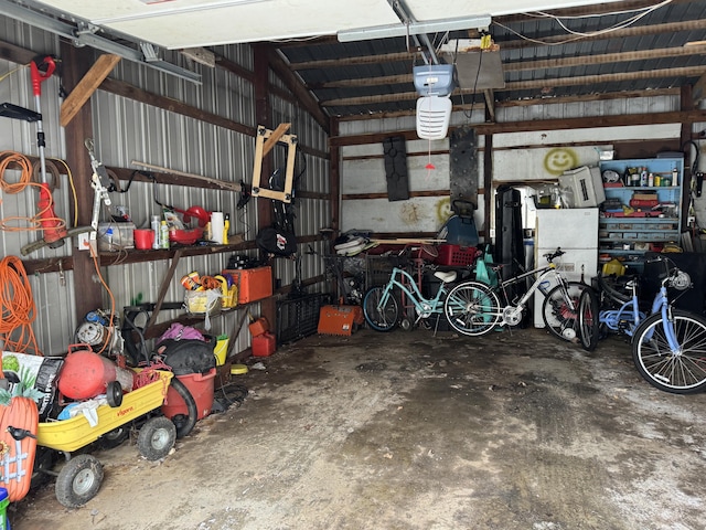 garage featuring metal wall and a garage door opener