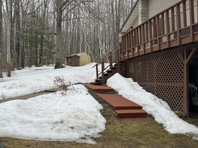 yard layered in snow featuring stairway