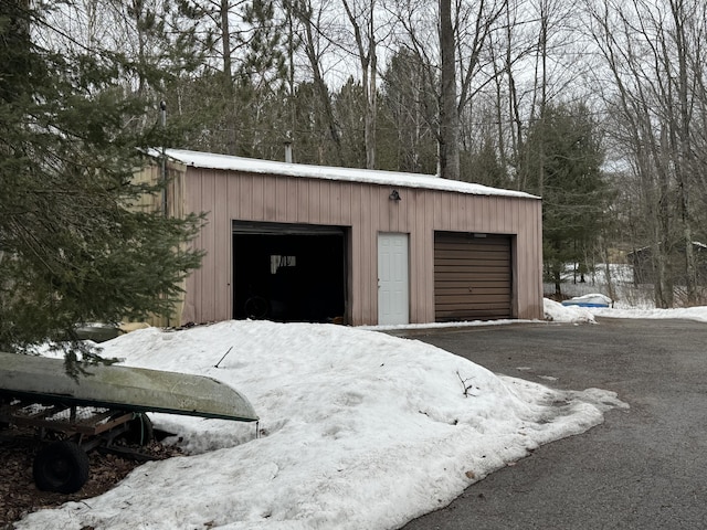 snow covered garage with a garage