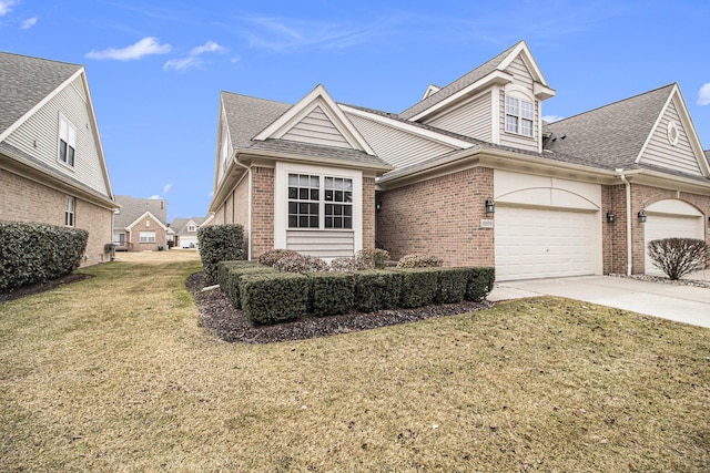 view of front of home with a front yard, concrete driveway, and brick siding