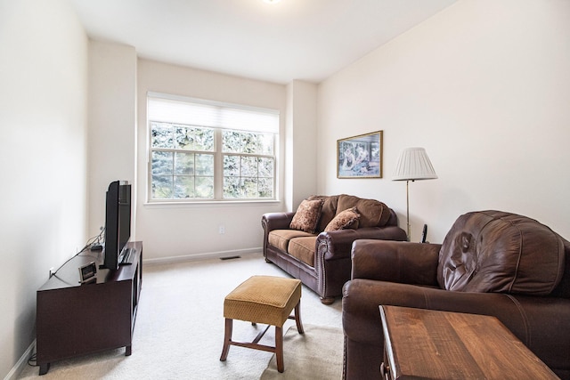 living room with light carpet, visible vents, and baseboards