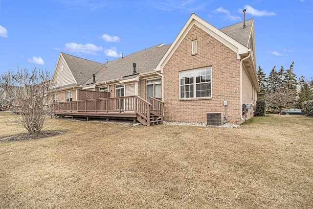 back of property featuring a yard, a deck, cooling unit, and brick siding