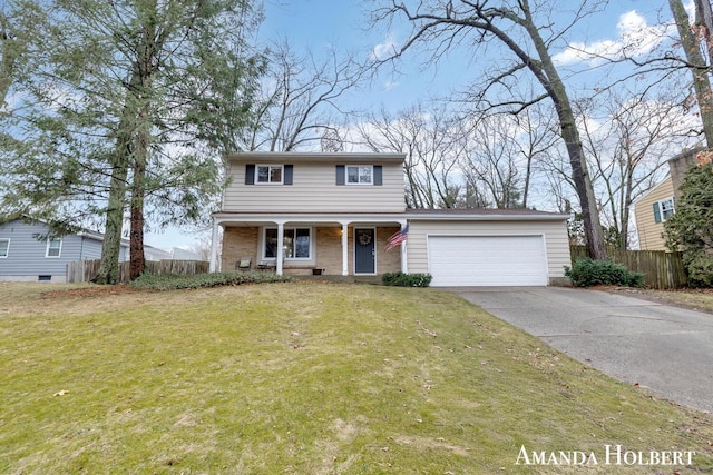 traditional home featuring a garage, concrete driveway, fence, a front yard, and brick siding