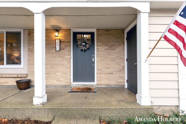 doorway to property with brick siding