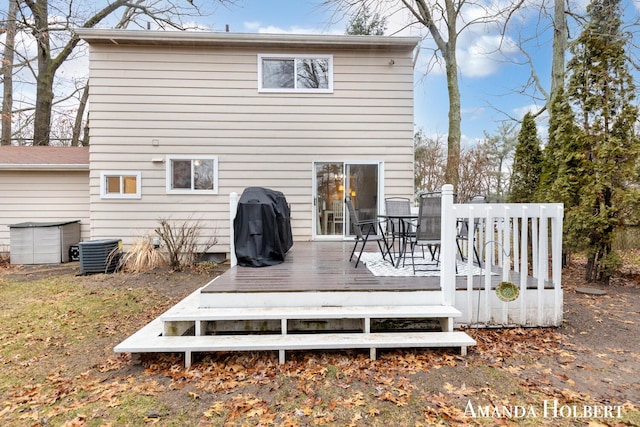 back of property with cooling unit and a deck