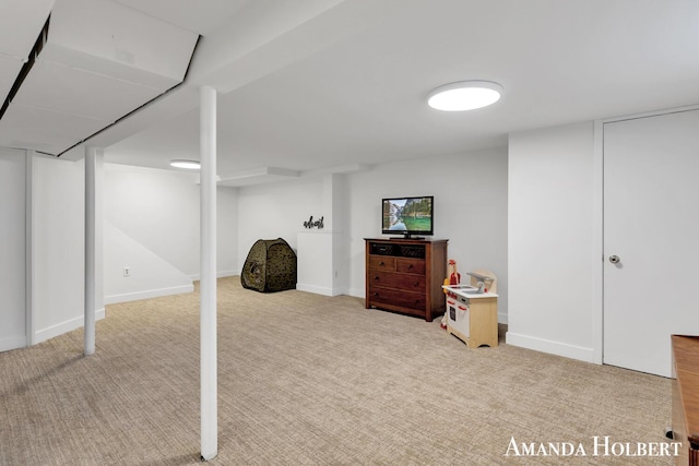 finished basement featuring baseboards and light colored carpet