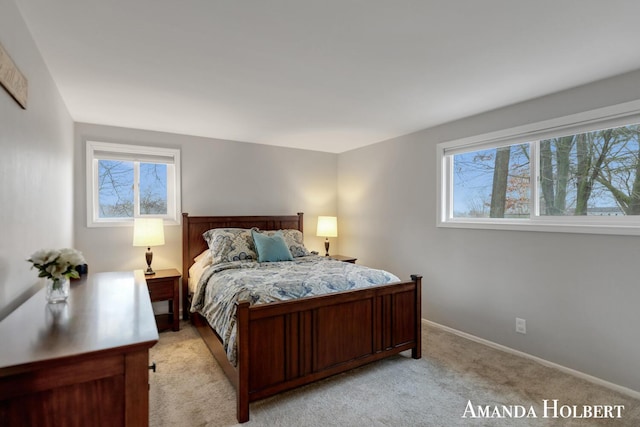 bedroom featuring baseboards and light colored carpet