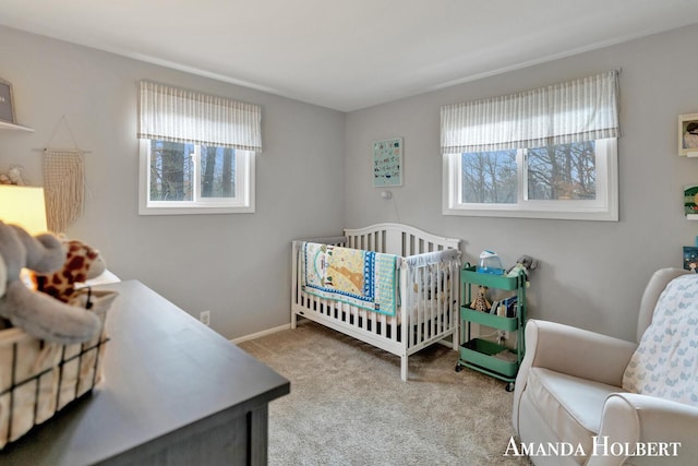 carpeted bedroom with a nursery area and multiple windows