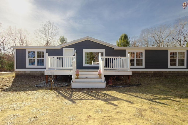 rear view of property featuring a deck