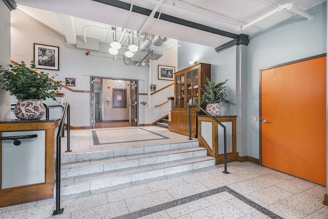 entryway featuring stairs and baseboards