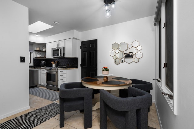 kitchen with open shelves, backsplash, appliances with stainless steel finishes, light tile patterned flooring, and white cabinets