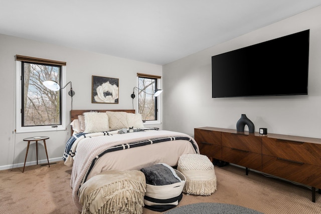 bedroom featuring baseboards and light colored carpet