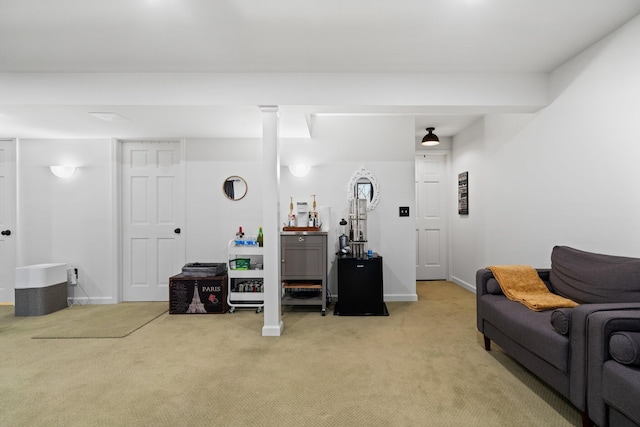 living area featuring light carpet and baseboards