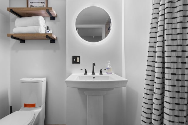 bathroom with toilet and a sink