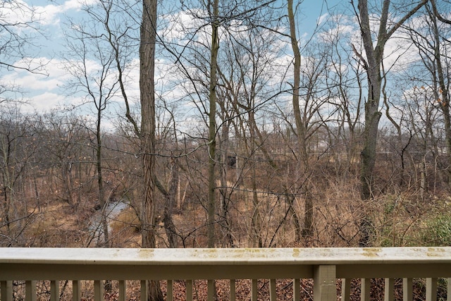 exterior space featuring a wooded view