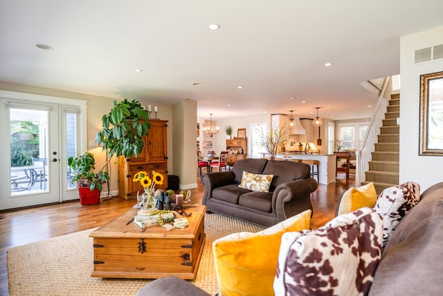 7881 Lakewood Dr, Coloma, MI 49038 - living room featuring wood finished floors, a chandelier, stairs, and recessed lighting