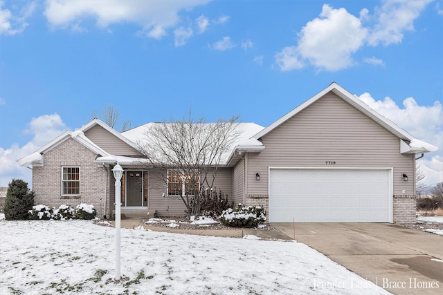 ranch-style home featuring driveway, brick siding, and an attached garage