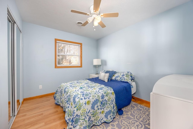 8581 Lynwood Ln, Mecosta, MI 49332 - bedroom with light wood-style floors, a ceiling fan, baseboards, and a closet