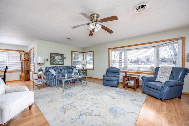 8581 Lynwood Ln, Mecosta, MI 49332 - living room with a ceiling fan, visible vents, a wealth of natural light, and wood finished floors