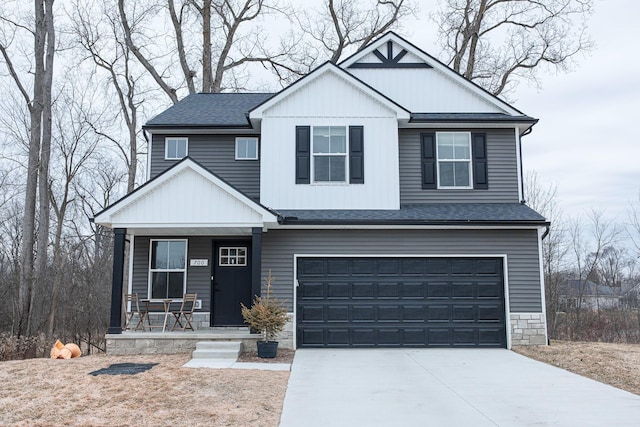 view of front of house featuring concrete driveway, roof with shingles, an attached garage, covered porch, and board and batten siding