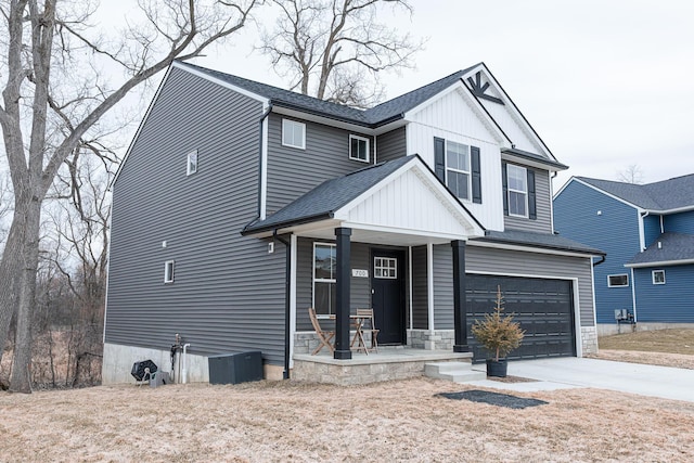 view of front facade with a porch, an attached garage, a shingled roof, driveway, and board and batten siding