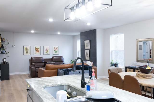 interior space with light wood finished floors, baseboards, and recessed lighting