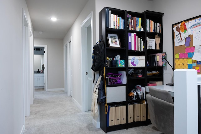 hallway with carpet floors and baseboards