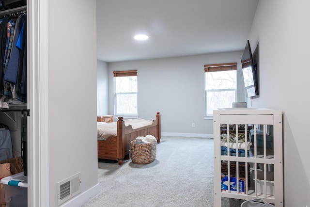 bedroom featuring carpet floors, a closet, visible vents, and baseboards