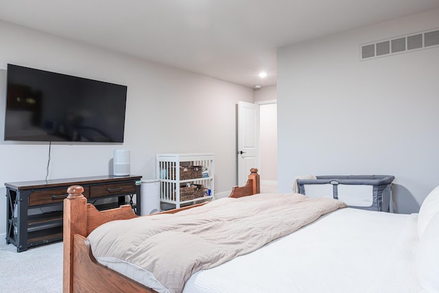 carpeted bedroom with visible vents and recessed lighting