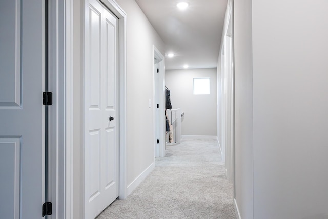 hall with recessed lighting, baseboards, and light colored carpet