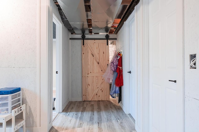 interior space featuring a barn door and wood finished floors