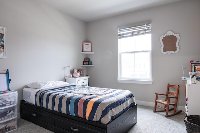 bedroom with baseboards and light colored carpet