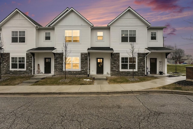 townhome / multi-family property with stone siding and board and batten siding