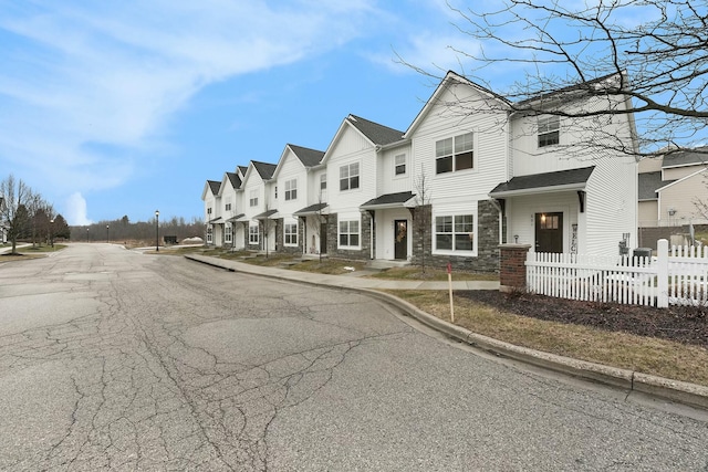 view of road with curbs, sidewalks, and a residential view