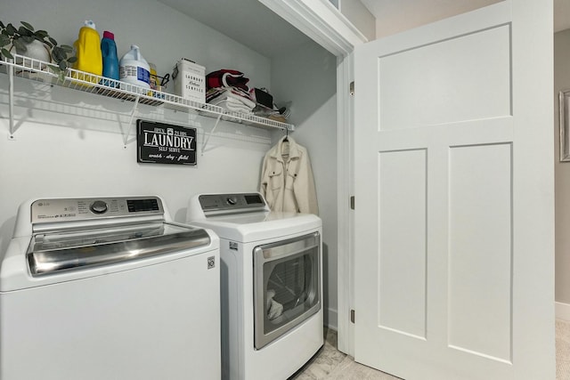 clothes washing area with washer and dryer and laundry area