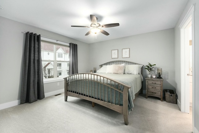 carpeted bedroom featuring a ceiling fan and baseboards