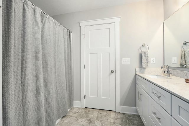 bathroom featuring vanity and baseboards