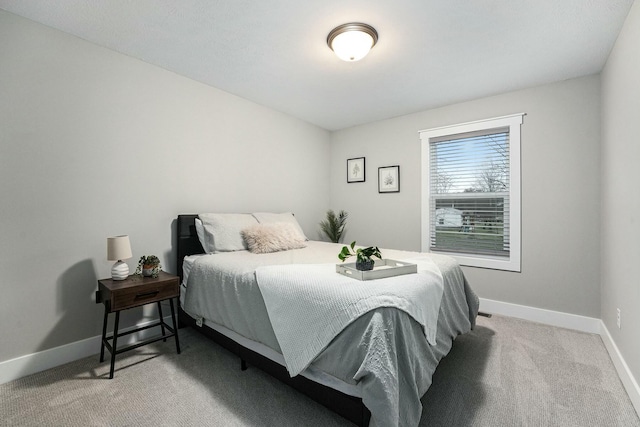 carpeted bedroom featuring baseboards