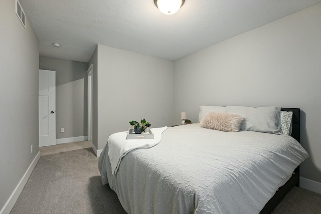 bedroom with carpet floors, visible vents, and baseboards