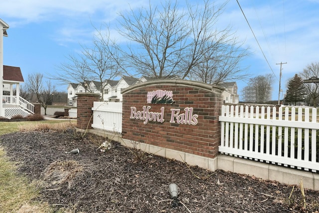 community sign featuring fence