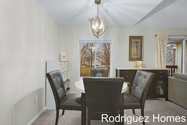 carpeted dining space with a notable chandelier and baseboards