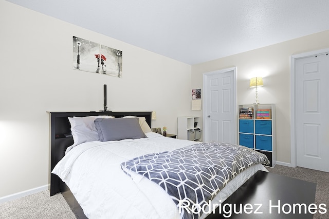 carpeted bedroom with baseboards